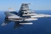 An F/A-18 carries the new Harpoon Block II+ missil