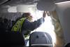 An NTSB investigator examines the Alaska 737 Max 9's after door-plug failure