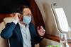 Business jet traveller with mask credit Shutterstock