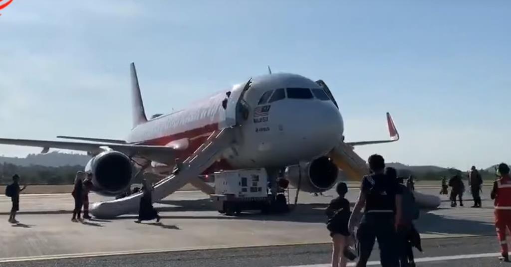 Passengers evacuate AirAsia A320 via slides, carrying bags | News ...