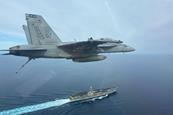 FA-18F over USS Harry S Truman aircraft carrier c US Navy