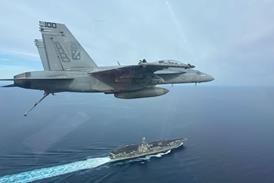 FA-18F over USS Harry S Truman aircraft carrier c US Navy