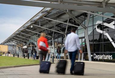 people-wheeling-suitcase-towards-entrance-of-southend-airport