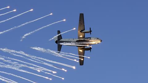 An Air Force C-27J Spartan aircraft dumps its flares during a handling display at Nobby's Beach during the Newcastle Williamtown Air Show 2023.