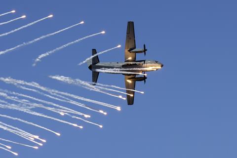 An Air Force C-27J Spartan aircraft dumps its flares during a handling display at Nobby's Beach during the Newcastle Williamtown Air Show 2023.