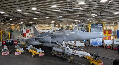 Rafale M in hangar with weapons