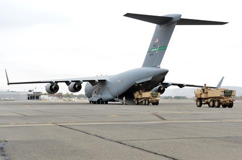 Two High Mobility Artillery Rocket System vehicles are loaded onto a C-17 Globemaster III c USAF