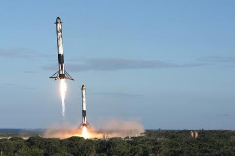 Two reusable rocket boosters land after the successful launch of the SpaceX Falcon Heavy rocket carrying a communications satellite at Kennedy Space Center, Fla - USSF