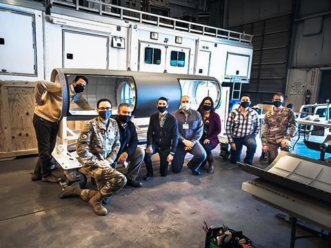 Members of the SHiELD program and their Boeing contractor team inspect the newly arrived SHiELD pod c AFRL