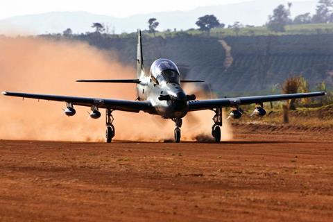 A-29 taking off dirt runway