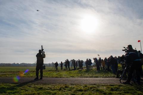 Soldier attempting to down a quadcopter using a counter-drone weapon c NATO