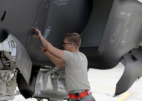 Crew member seals an F-35A Lightning II panel at Luke Air Force Base