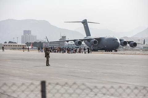 Evacuees load on to a United Arab Emirates (UAE) Boeing C-17 Globemaster III during an evacuation at Hamid Karzai International Airport, Kabul, Afghanistan, Aug. 21.