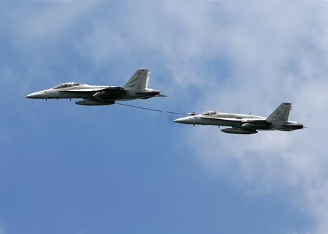 FA-18F Super Hornet and an FA-18C Hornet from Naval Air Station North Island demonstrate their mid-air refueling capabilities c USN