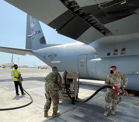 USAF airman use Fuel Powered Additive Injector Cart to convert commercial-grade fuel to military-grade fuel in Saudi Arabia c USAF