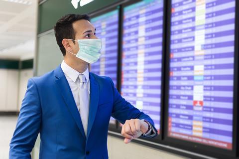 Mask business traveler shutterstock_1735211177