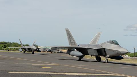 F-22s with external drop tanks taxi at Hickam AFB Hawaii c USAF