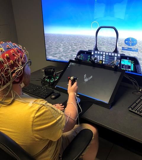 Subject's brain activity is watched during piloting simulation c AFRL