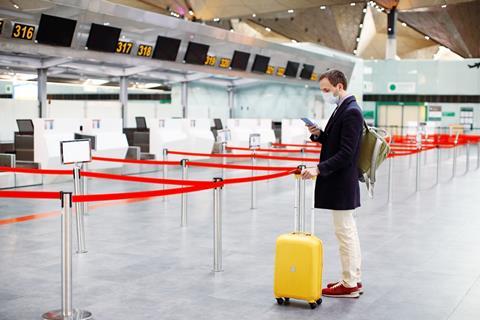 Man on phone at airport c Shutterstock