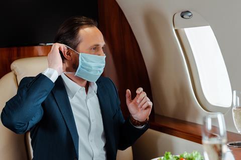 Business jet traveller with mask credit Shutterstock