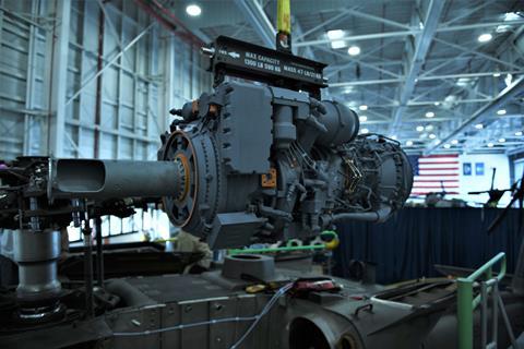 A 3D printed model of the GE T901 engine hangs from its sling waiting to be installed in an UH-60M c US Army